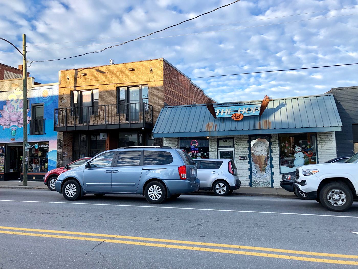 Haywood Road in West Asheville, storefronts including The Hop West ice cream shop